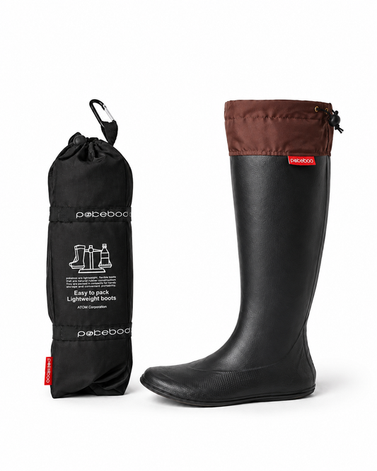 Black Original Pokeboo rubber boot with brown top and drawstring bag on a white background