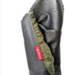 A blackPokeboo TREAD  rubber boot folded up with an olive green fabric cuff and a red 'pokeboo' brand tag, shown on a plain white background.